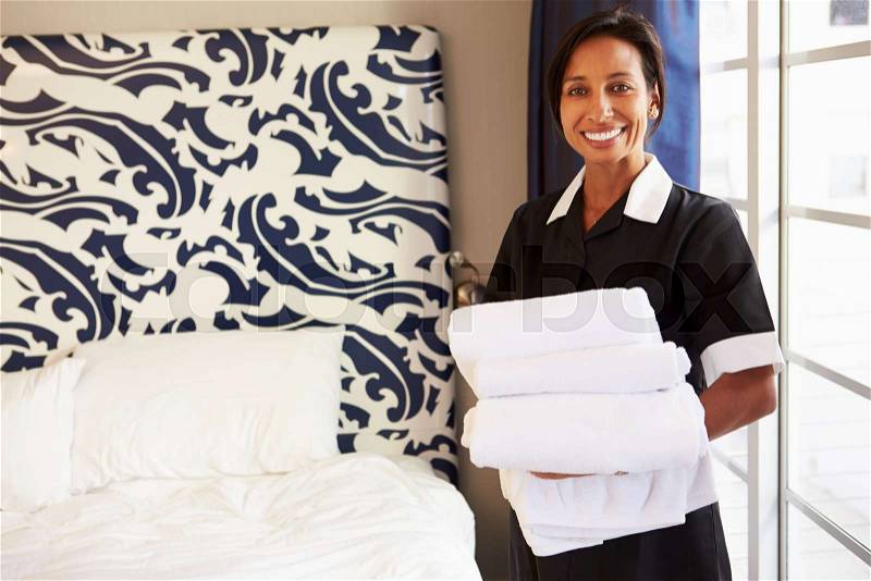 Portrait Of Maid Tidying Hotel Room, stock photo