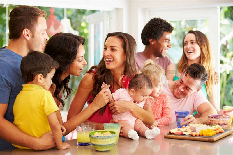 Group Of Families Enjoying Snacks At Home, stock photo