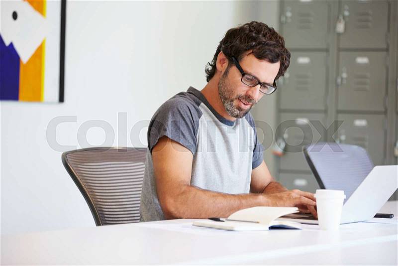Casually Dressed Man Working In Design Studio, stock photo