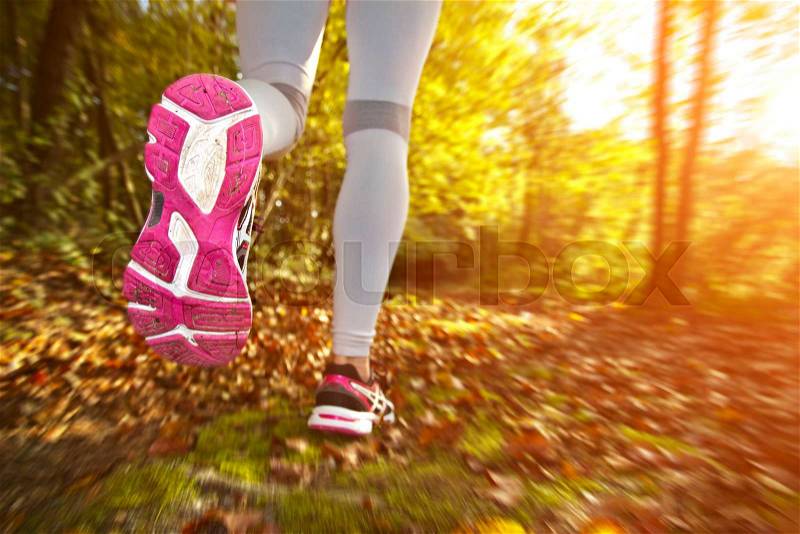 Fitness Girl running in forest with colorful outfit, stock photo