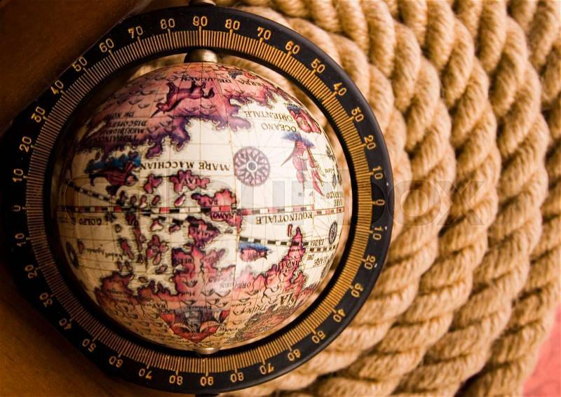 Compass on old map, ambient light travel theme, stock photo