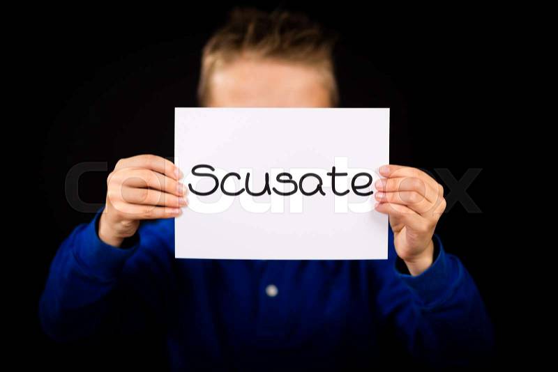 Studio shot of child holding a sign with Italian word Scusate - Sorry, stock photo