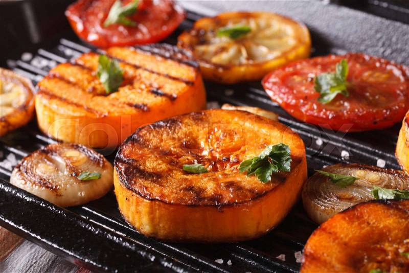 Grilled pumpkin and vegetables on the grill pan. Horizontal macro, rustic style , stock photo