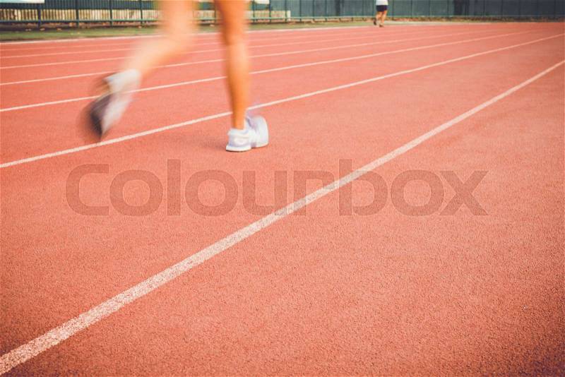 Close up Running track with blur of runner feet in stadium, stock photo