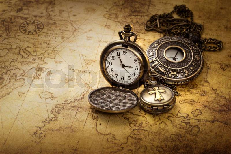Vintage antique pocket watch on old map background, stock photo