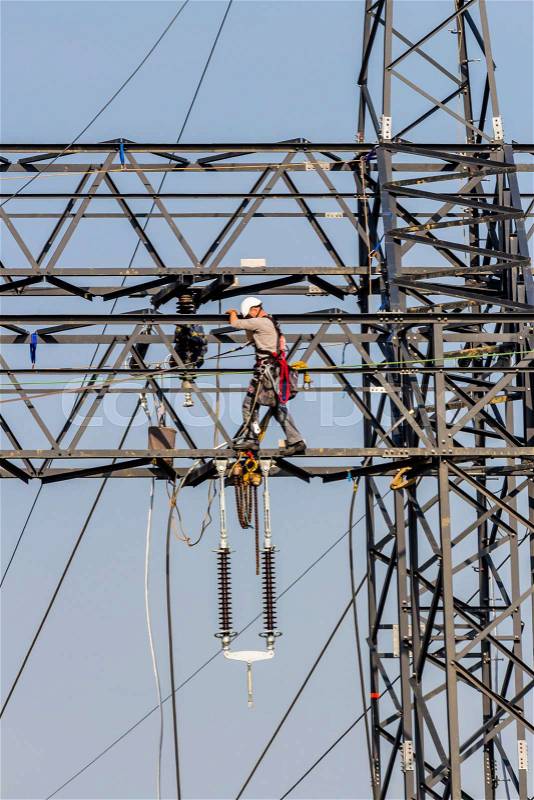 Construction of a new high-voltage line. workers on electricity pylons, stock photo