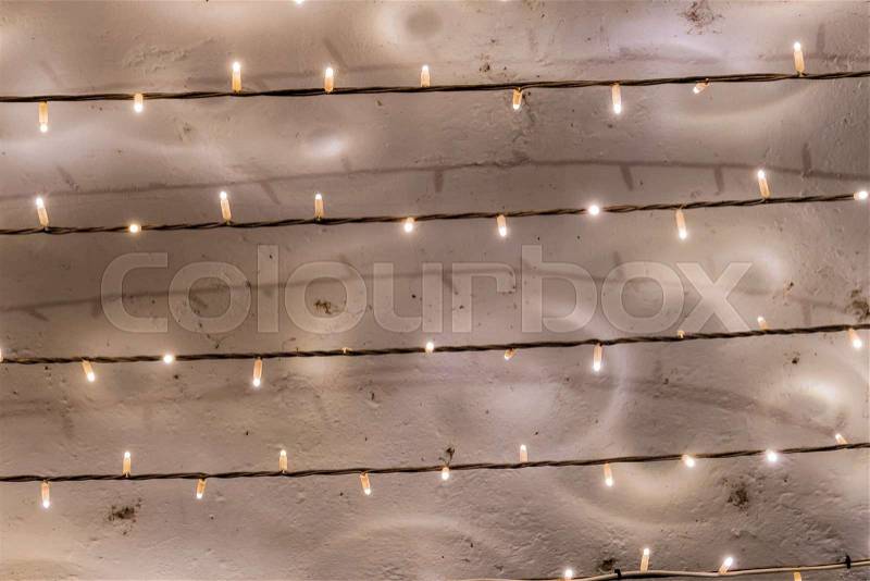 Fairy lights bulbs in series, a symbol of power consumption, decoration, networking, stock photo