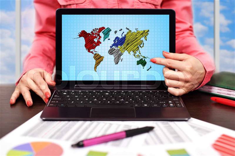Businesswoman pointing to screen laptop with world map, stock photo