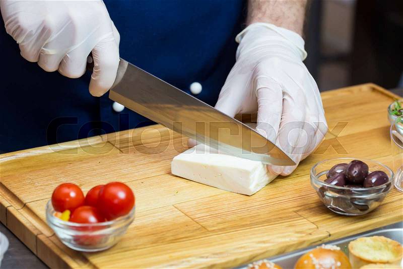 Cook prepares canapes in the kitchen at the restaurant, stock photo