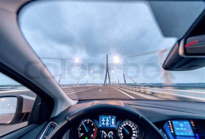 Crossing the bridge with a modern car, cockpit view, stock photo