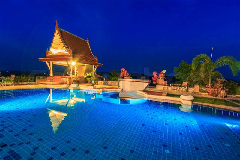 Modern resort with swimming pool at night, stock photo
