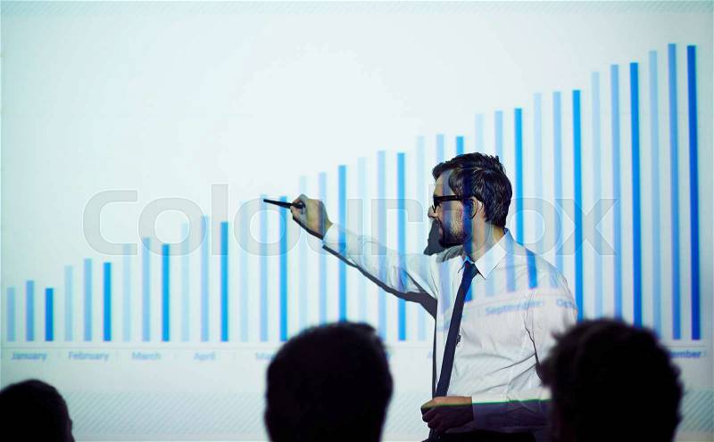 Handsome manager presenting report of progress in business, stock photo
