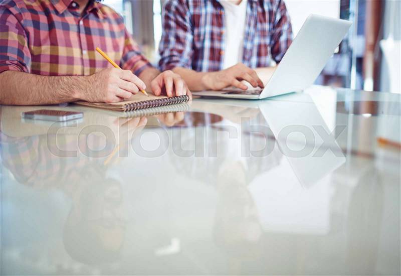 Close-up of business colleagues planning work, stock photo