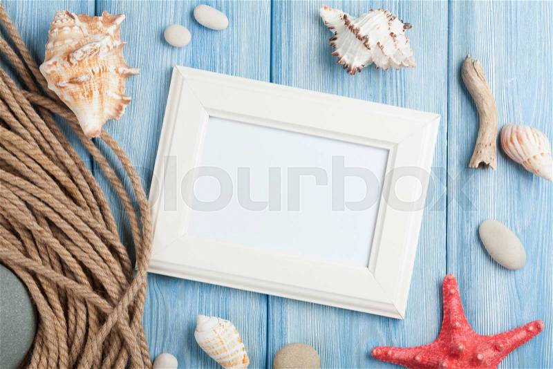 Summer time sea vacation with blank photo frame, star fish and marine rope, stock photo