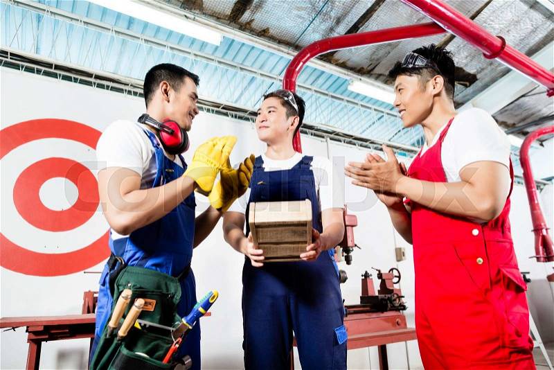 Team of Asian workers discussing product as a work team, stock photo