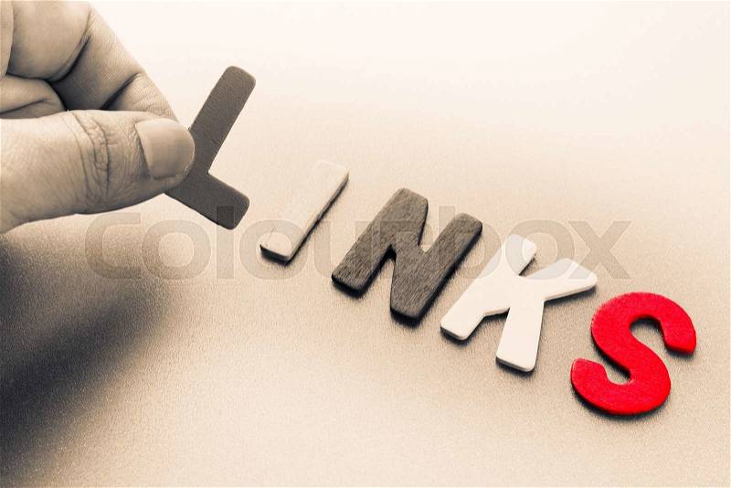 Finger pick a wood letters of Links word, stock photo