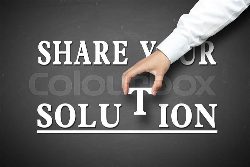 Share your Solution concept with businessman hand holding against blackboard background, stock photo