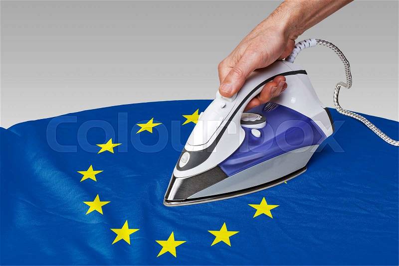 Steam iron for smooth out the wrinkles of Flag from Europe, stock photo