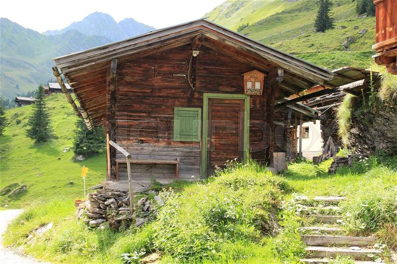 Wooden cottage in the mountains in the summer in Austria, stock photo