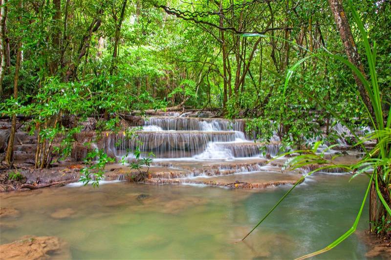 Waterfall in deep rain forest jungle. (Huay Mae Kamin Waterfall in Kanchanaburi Province, Thailand), stock photo