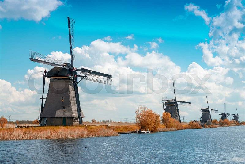 Dutch windmills with canal reflections at Kinderdijk, Netherlands, stock photo
