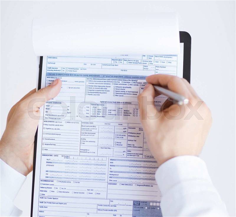 Close up of male doctor holding prescription paper in hand, stock photo