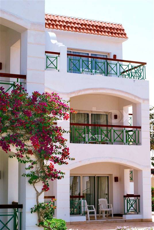 Facade of Hotel with balconies and windows decorated with flowers Sharm El Sheikh, Egypt, stock photo