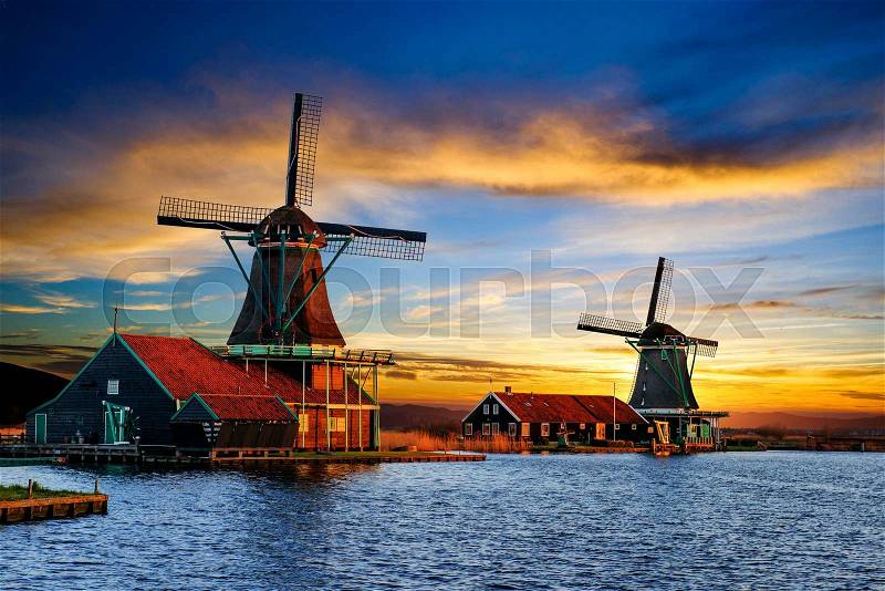 Cumulus clouds on sunset over dutch windmills in Rotterdam. Netherlands, stock photo