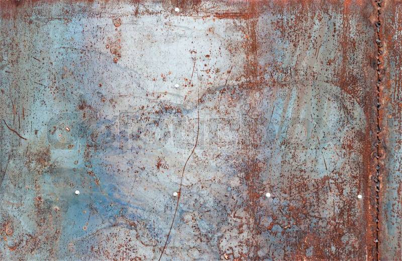 Scratched and rusty orange metal surface as background, stock photo