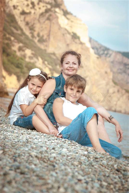 Happy family on the beach, stock photo