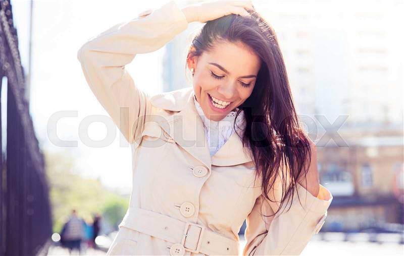 Portrait of a laughing pretty woman outdoors, stock photo