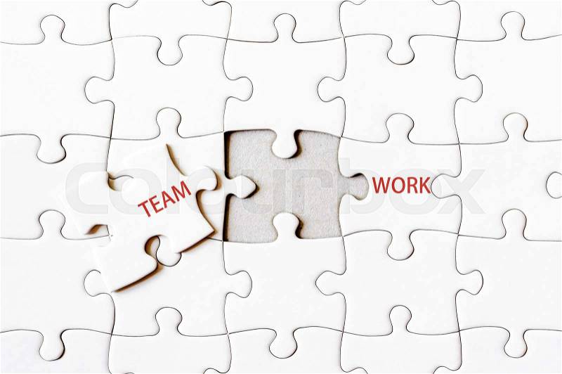 Missing jigsaw puzzle piece completing word TEAMWORK. Business concept image for completing the final puzzle piece, stock photo
