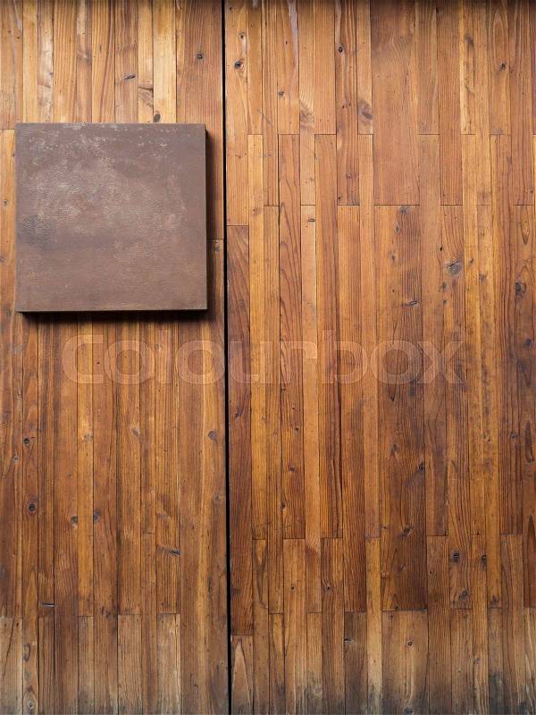 Metal plate on wood plank background, stock photo