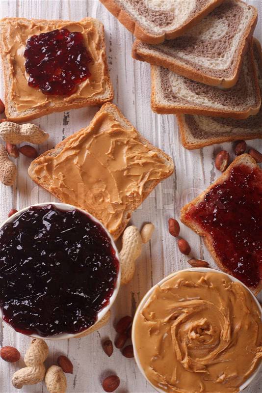 Toast with peanut butter and jam closeup on the table. vertical top view\, stock photo