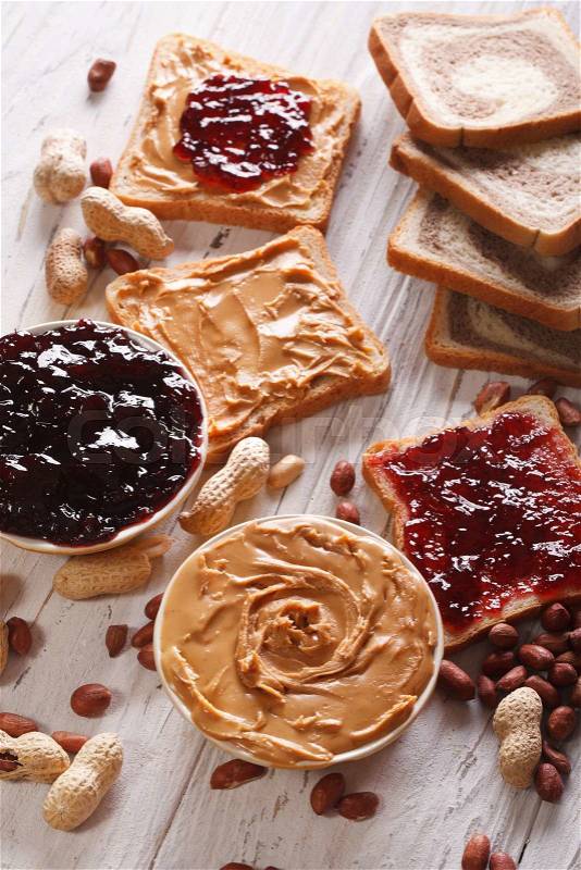 Toast with peanut butter and jelly close-up on the table. vertical\, stock photo