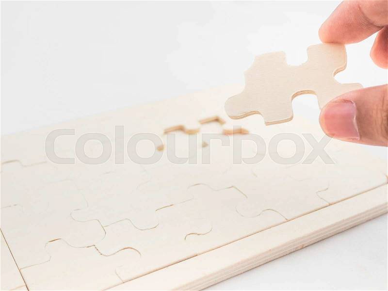 Hand holding last puzzle, business concept, stock photo