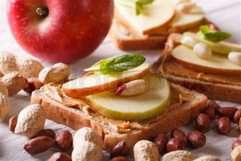 Sweet sandwich with peanut butter and apple close up. Horizontal , stock photo