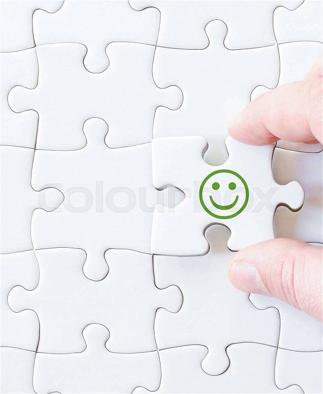 Missing jigsaw puzzle piece with smiling emoticon face. Business concept image for completing the puzzle, stock photo