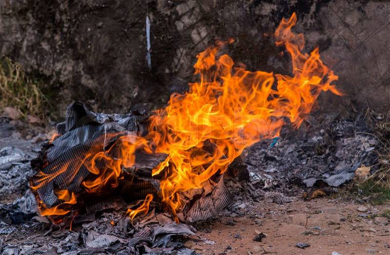 Burning papers and box with flames and ash, stock photo