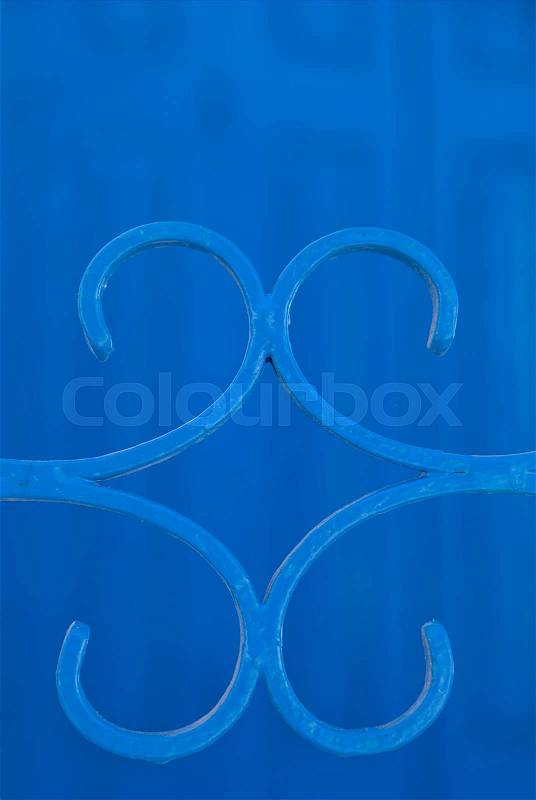 Detail of blue metal gate, in front of blue door. , stock photo