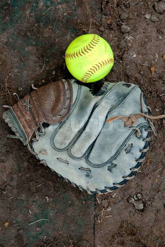 Softball Ball Lying on the Ground Near the Glove. Picture, Photo, stock photo