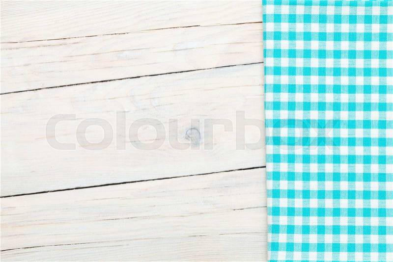 Blue towel over wooden kitchen table. View from above with copy space, stock photo