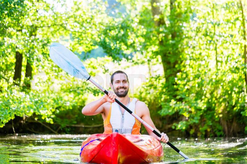 Man paddling with kayak on river for water sport, stock photo