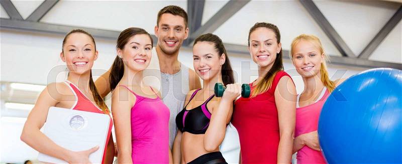 Fitness, sport, training, gym and lifestyle concept - group of smiling people in the gym, stock photo