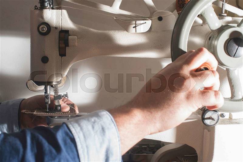 Sewing leather. Manual machine, stock photo
