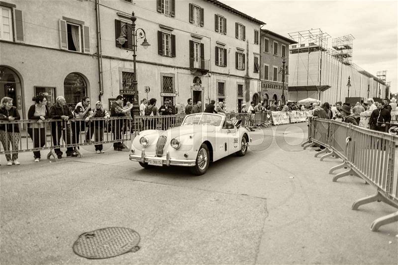 PISA, ITALY - MAY 16, 2015: Mille miglia competition car along city streets. The old car parade takes place from 14th to 17th May 2015, stock photo