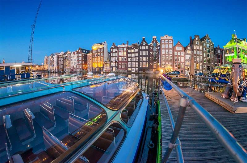 Beautiful night skyline of Amsterdam. City homes along canal, stock photo