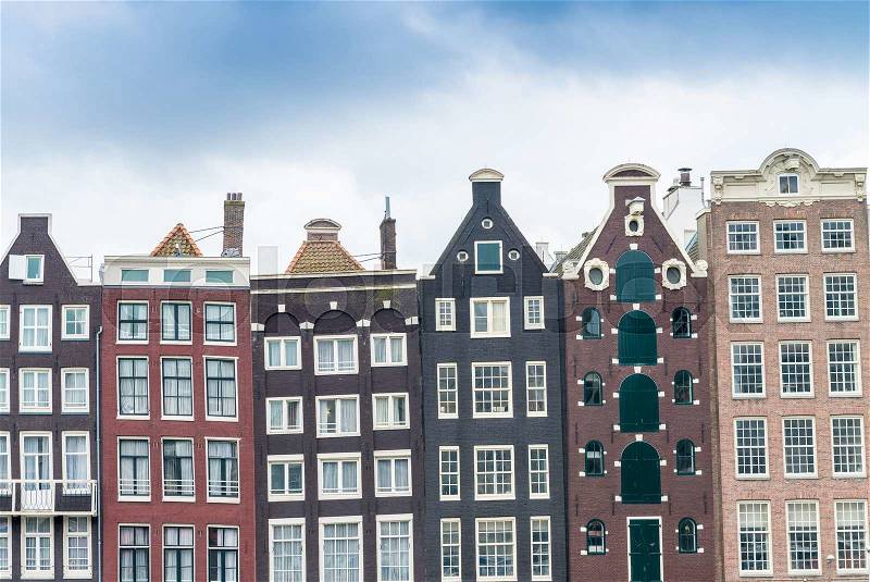 Beautiful houses of Amsterdam along city canal, stock photo