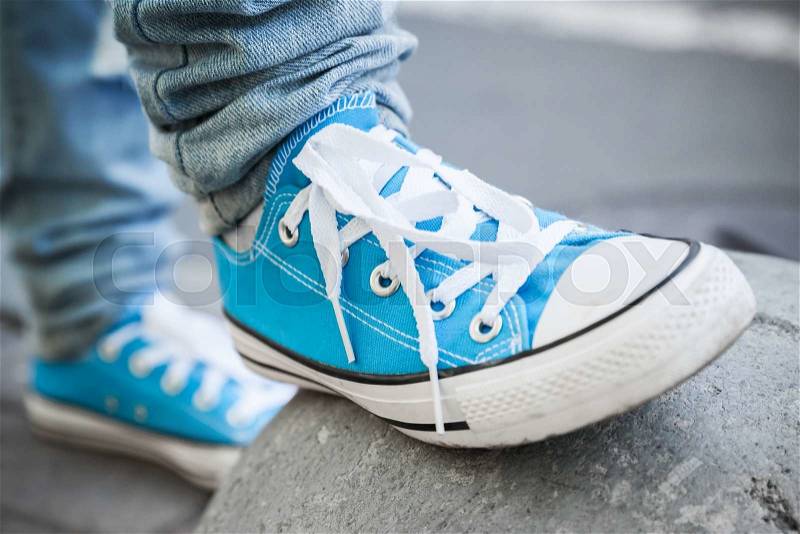 Brand new blue shoes, urban walking theme. Closeup photo with selective focus and shallow DOF, stock photo