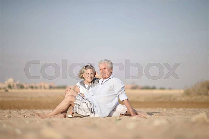 Amusing happy elderly couple on the beach, stock photo